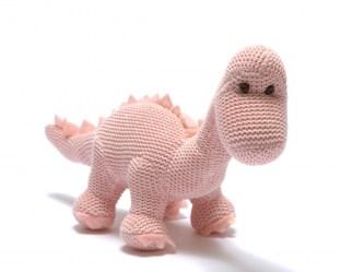Pastel pink knitted diplodocus dinosaur baby toy with long neck.